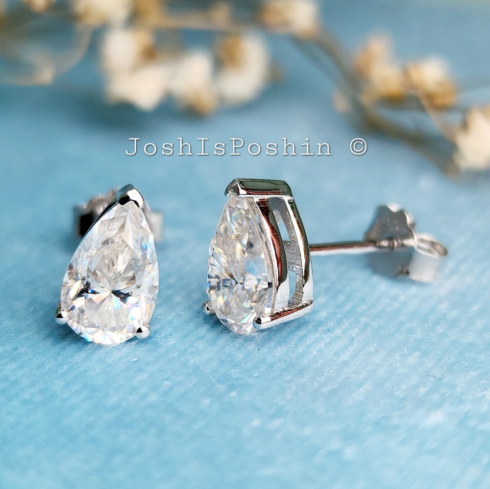 Pear-shaped moissanite three prong stud earrings in sterling silver